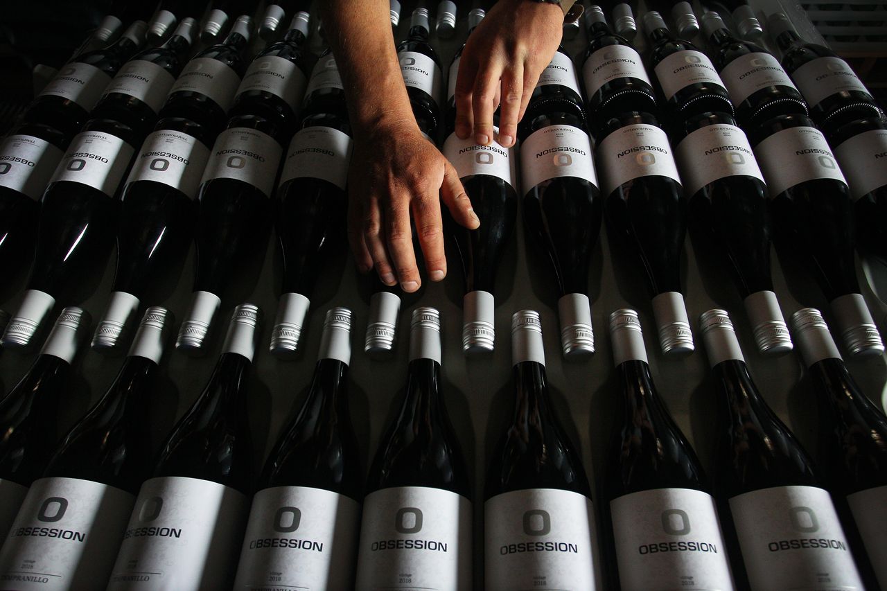 Adrian Brayne handles wine stock in the processing building at Obsession Wines on Nov. 24, 2020 in Tumbarumba, Australia.
Lisa Maree Williams/Getty Images