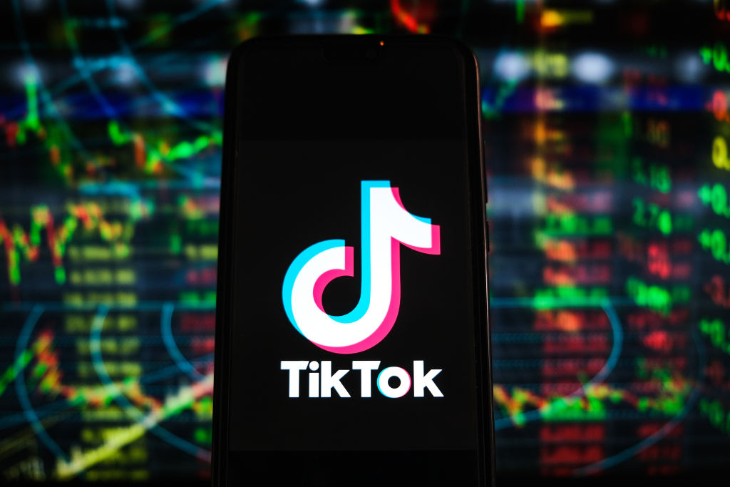 POLAND - 2021/04/26: In this photo illustration a TikTok logo is displayed on a smartphone with stock market percentages in the background. (Photo Illustration by Omar Marques/SOPA Images/LightRocket via Getty Images)
