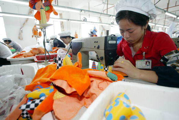 SHENZHEN, CHINA:  Woman sew toys in a factory in the southern Chinese city of Shenzhen 24 October 2002. Shenzhen is an economic boomtown where many foreign entrepreneurs have set up factories taking advantage of abundant cheap labour. AFP PHOTO/Peter PARKS (Photo credit should read PETER PARKS/AFP via Getty Images)