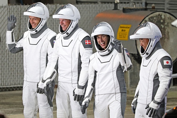 Roscosmos cosmonaut Konstantin Borisov, European Space Agency (ESA) astronaut Andreas Mogensen, NASA astronaut Jasmin Moghbeli, and Japan Aerospace Exploration Agency (JAXA) astronaut Satoshi Furukawa, wave as they prepare to depart the Neil  A. Armstrong Operations and Checkout Building for Launch Complex 39A to board the SpaceX Dragon spacecraft for the Crew-7 mission launch, at NASA's Kennedy Space Center in Florida, on August 26, 2023. (Photo by GREGG NEWTON/AFP via Getty Images)